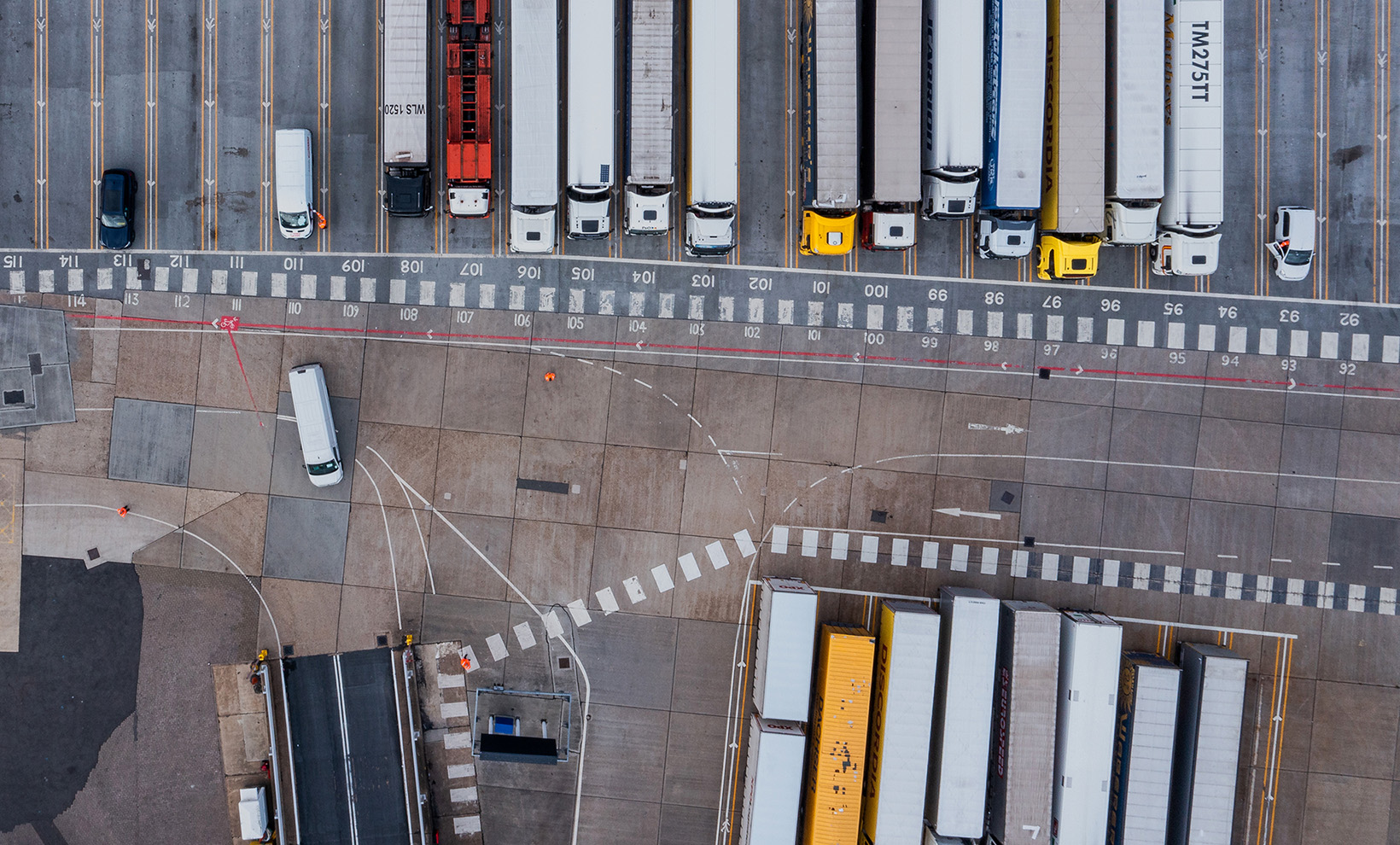 Aerial view of harbor and trucks parked along side each other getting ready for embarking the Dover Ferry to Calais